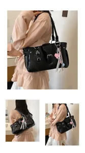 Retro black shoulder bag for women with metal buckles and cute pink heart charm detail.