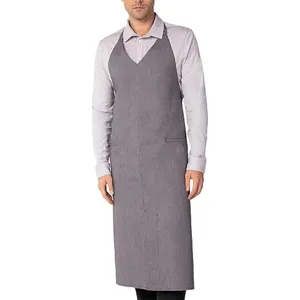 Detailed view of the grey kitchen apron, showcasing its V-neck halter design and front pockets.