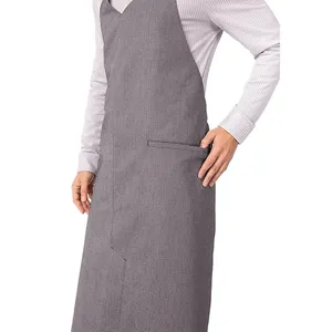 Detail shot of grey work apron showing V-neck design, durable fabric texture, and front pocket.