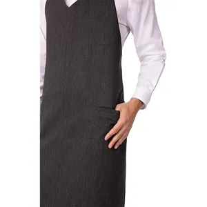 Dark grey professional work apron with V-neck and practical front pocket for kitchen and cafe use.