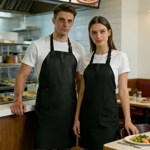 Durable black waterproof kitchen apron with front pockets for cooking and restaurant work.