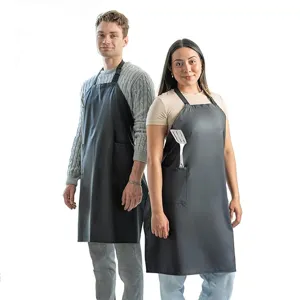 Black waterproof kitchen apron with front pockets, durable fabric for cooking and daily use.