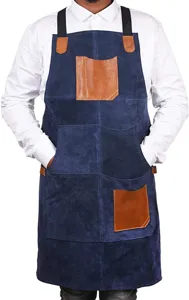 Detail view of durable blue leather work apron with contrast brown pockets for kitchen baking.