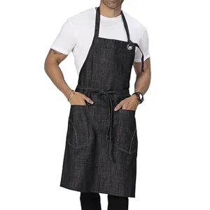 Dark denim work apron with multiple front pockets and neck strap detail worn by model