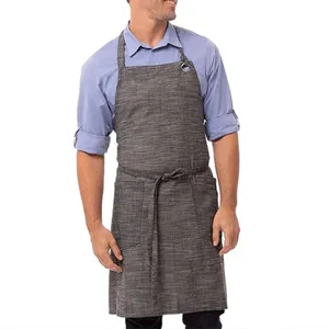 Detail shot of men's cotton linen apron with pockets and neck strap for baking and cooking.