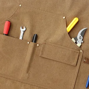 Heavy duty canvas work apron with multiple utility pockets and reinforced metal rivets for tools.