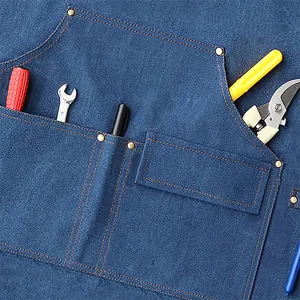 Durable thick canvas work apron with multiple tool pockets, ideal for workshop or BBQ use.