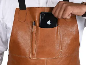 Close-up detail of premium brown PU leather work apron with chest pocket and pen holder.