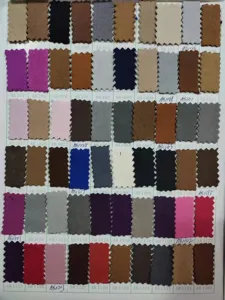 Detail view of multi-color leather fabric swatch card for custom apron manufacturing options.