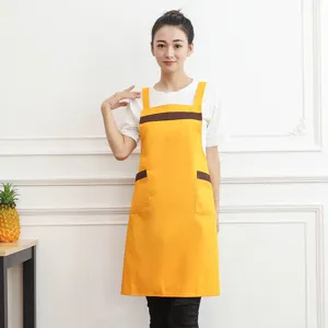 Korean style yellow kitchen apron with brown pockets, durable fabric for home cooking and baking.