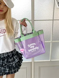 Transparent purple tote bag with green handles, stylish large capacity PVC handbag.