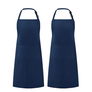 Close-up details of solid navy blue work aprons with adjustable neck straps and pockets.