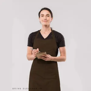 Female model wearing dark brown kitchen work apron holding a notebook detail view.