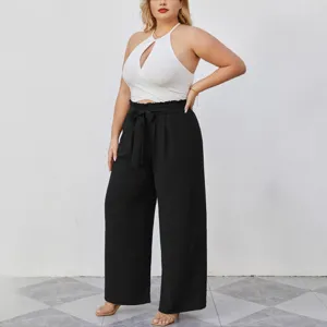 Completo taglie forti donna top corto halter e pantaloni larghi neri estivi casual.