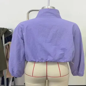 Purple zip-up stand collar cropped jacket back detail showing elastic hem and long sleeves.