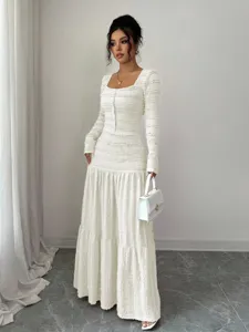 Elegant white textured long sleeve maxi dress with square neck and buttons for women.