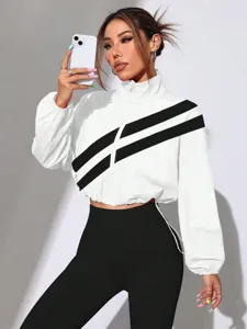 Detailed view of the women's white cropped stand-collar jacket featuring black diagonal stripes.