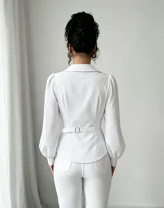 Detailed view of the back of a white lapel long sleeve shirt with a belted waist design.