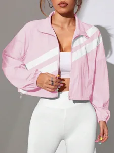 Detail view of the pink cropped windbreaker jacket featuring white diagonal stripes and zip.