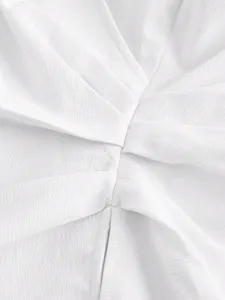 Close-up detail of white V-neck cross wrap blouse showing delicate textured fabric drape.