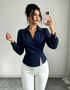 Close-up detail of the dark blue wrap blouse showing V-neck and ruched waist design.