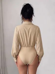 Detailed back view of a chic beige vertical striped lapel long sleeve bodysuit shirt.