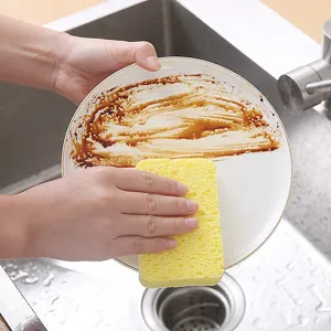 Wood pulp dishwashing sponge, highly absorbent cleaning pad for pots and plates in kitchen.