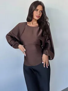 Close-up detail of the smooth satin texture and elegant long sleeve on women blouse.