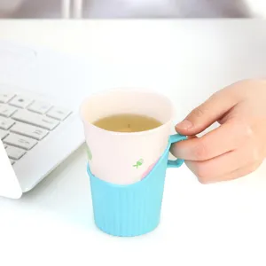 Disposable paper cup holder with plastic anti-scald sleeve for hot drinks and tea in hand view