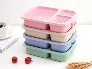 Multi-compartment wheat straw lunch box stack, eco-friendly food container in four pastel colors.