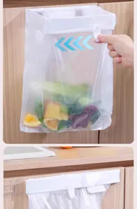 Detail view of wall-mounted garbage bag holder for kitchen cabinet door storage rack.