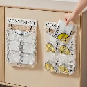 Wall-mounted mesh storage bag kitchen hanging garbage bag sundries organizer with velcro.