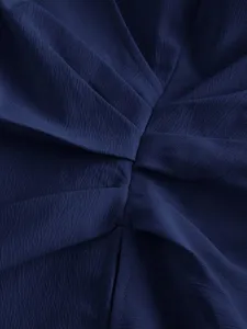 Detailed view of a dark blue women shirt fabric featuring elegant gathered twist pleats design.