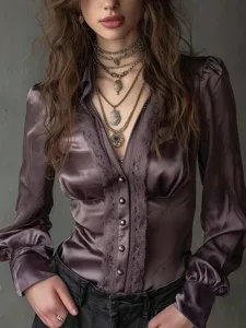 Detailed view of women's long-sleeve V-neck satin blouse featuring elegant lace trim.