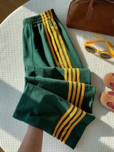 Vintage Y2K high waist casual track pants with striking yellow side stripes for women.