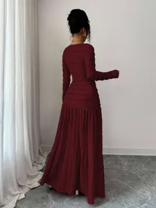 Long sleeve burgundy maxi dress with textured fabric detail, elegant design for women.