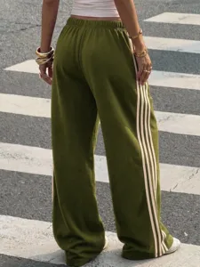 Olive green track pants detail showing side stripes, high elastic waist and drape soft fabric.