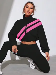 Detailed shot of black and pink diagonal stripe crop zip jacket on active studio model.