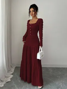 Detailed view of the burgundy textured long-sleeve maxi dress focusing on details.