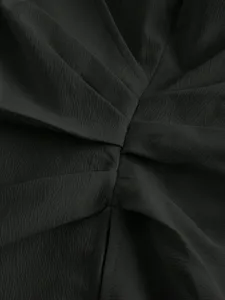Closeup of French style cross wrap blouse fabric detail, elegant pleated texture, dark tone.