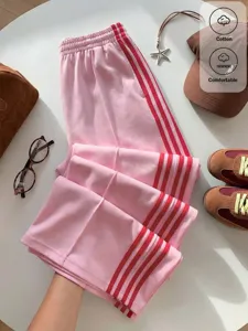 Detail shot of pink Y2K casual pants featuring red side stripes and soft fabric texture.
