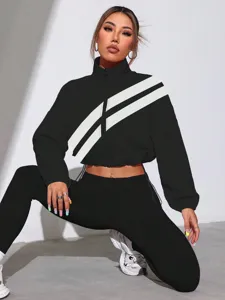 Cropped track jacket with chic diagonal stripes and stand collar, stylish activewear piece.