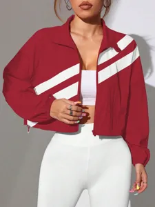 Close-up detail of the red and white color block cropped windbreaker jacket style.
