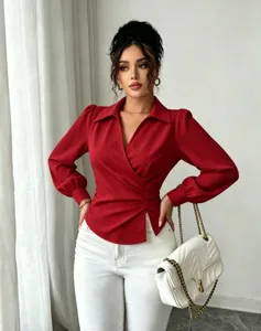 Detailed view of the elegant red wrap blouse featuring a lapel V-neck and stylish waist tie.