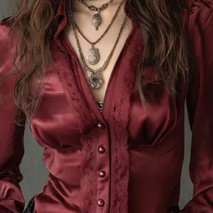 Elegant wine red satin women's long sleeve blouse with deep v neck, lace trim and buttons.