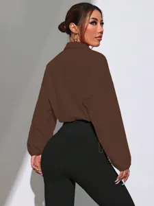 Brown crop jacket detail view, casual collared outerwear with long sleeves, solid style.