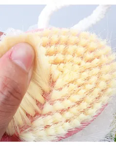 Soft bristle bath brush detail view, pink shower brush head, gentle exfoliating body scrubber.