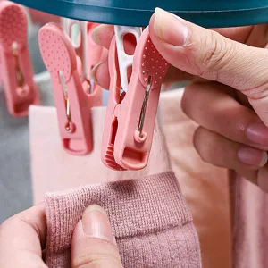 Plastic clothes clip detail shot, durable windproof peg for socks and underwear daily use.