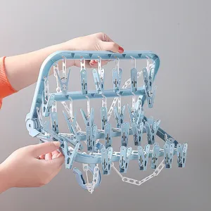 Foldable plastic clothes drying rack with multiple clips for socks and underwear at home.