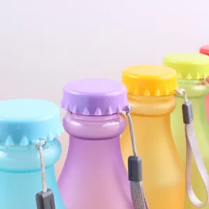 Candy color frosted plastic water bottle with creative cap design and portable strap for sports.